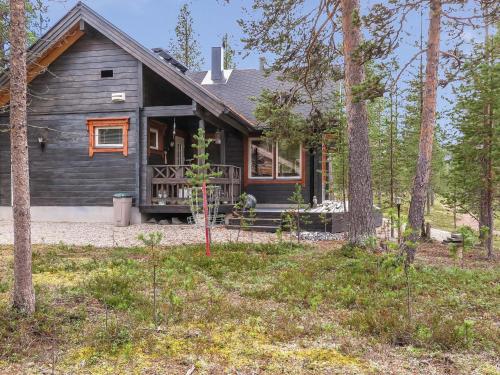 a log cabin with a porch in the woods at Holiday Home Homma by Interhome in Kyrö