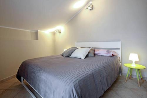 a bedroom with a large bed and a yellow table at B&B Portanova in Salerno
