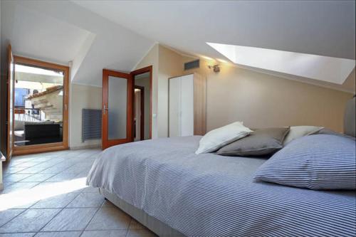 a bedroom with a large bed and a window at B&B Portanova in Salerno