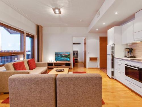 a living room with a couch and a table at Holiday Home Ski chalets 6405 by Interhome in Ylläsjärvi