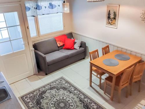 a living room with a couch and a table at Holiday Home Levi star 1009 by Interhome in Levi