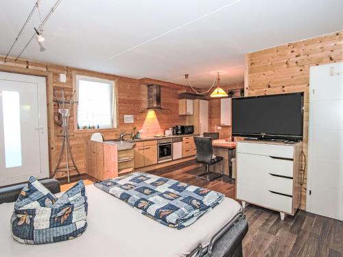 a room with a bed and a television and a kitchen at Apartment Barbara-2 by Interhome in Fügen