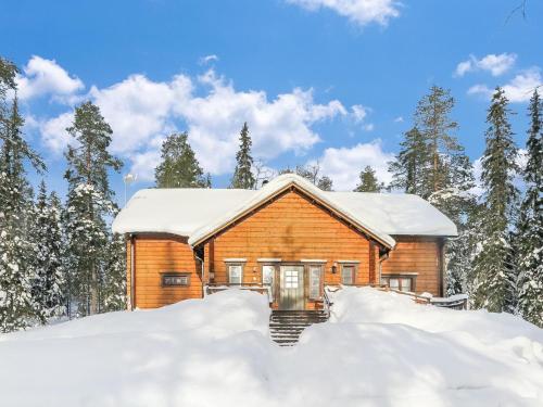 a log cabin in the snow at Holiday Home Tervakko by Interhome in Luosto