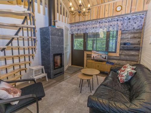 a living room with a couch and a fireplace at Holiday Home Kantapää d2 by Interhome in Luosto