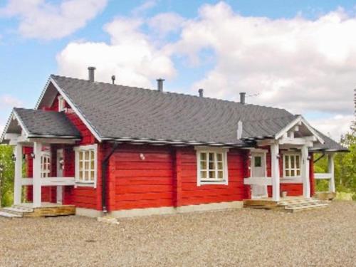 a red house with a gray roof at Holiday Home Vuonkuma by Interhome in Äkäslompolo