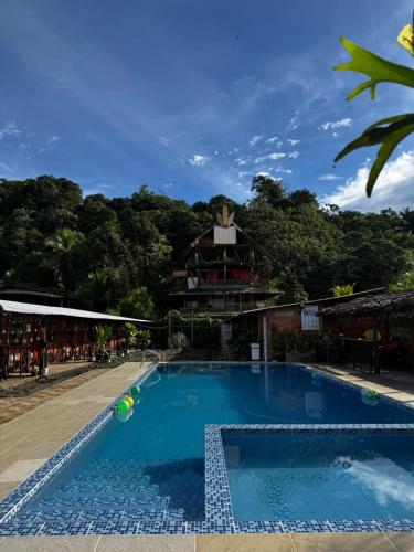 a pool at a resort with a building in the background at Playa Lodge in El Valle