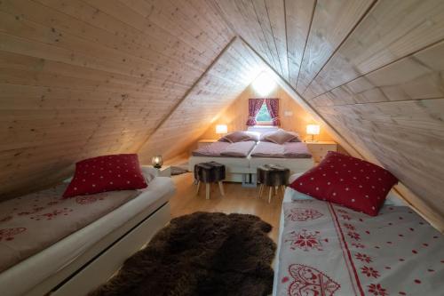 a room with two beds in a attic at Geofond Chaty in Chotěboř