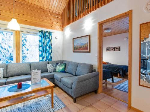 a living room with a couch and a table at Holiday Home Aamutähti by Interhome in Äkäslompolo