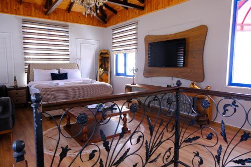 a bedroom with a bed and a balcony with a television at AYBELYA TATİL KÖYÜ in Bafra