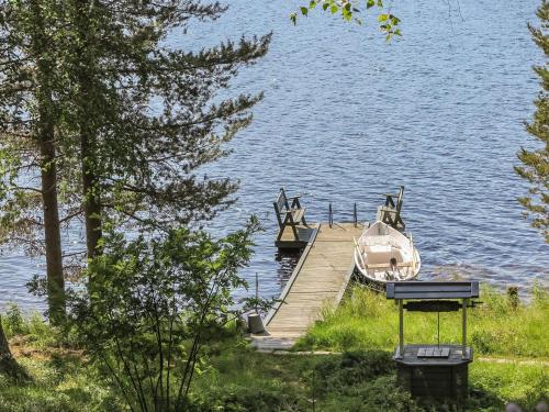 a boat is docked at a dock on a lake at Holiday Home Sipukka by Interhome in Meltaus