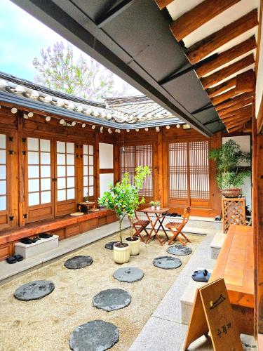 a pavilion with a table and chairs in a room at JoongRimJae - Hanok in Seoul