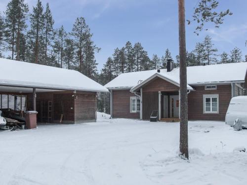 a house with snow on the roofs in the yard at Holiday Home Seppola by Interhome in Ruka