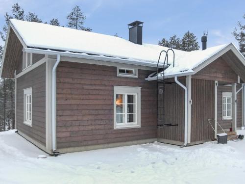 a small house with snow on the roof at Holiday Home Seppola by Interhome in Ruka