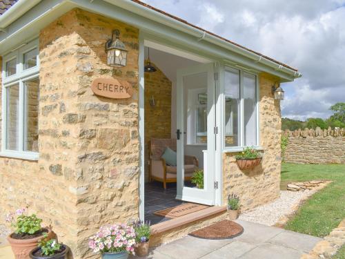a stone cottage with a sign on the door at Cherry Cottage - Ukc3990 in South Perrott