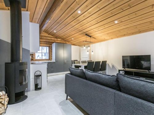 a living room with a couch and a fireplace at Holiday Home Honkakeko by Interhome in Levi