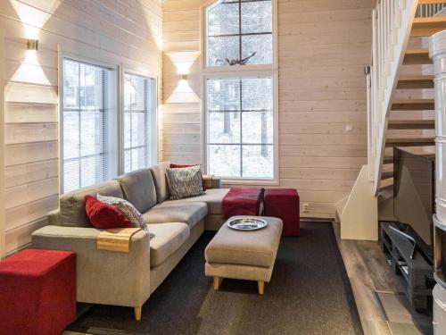 a living room with a couch and a tv at Holiday Home Maaruska a by Interhome in Äkäslompolo