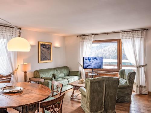 a living room with a couch and a table at Apartment Chesa Sonnalpine B 48-4 by Interhome in St. Moritz