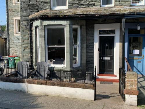 a building with a window with a dog in it at 2 Windsor House in Keswick