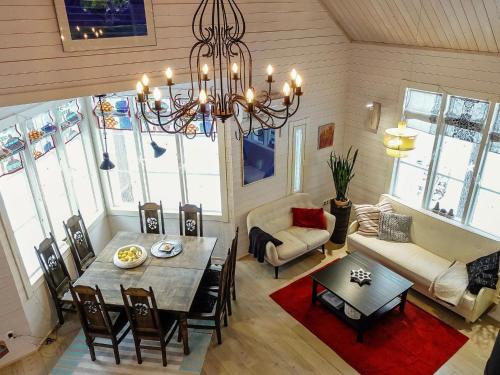 a living room with a table and a chandelier at Holiday Home Teppolan rinne by Interhome in Salla
