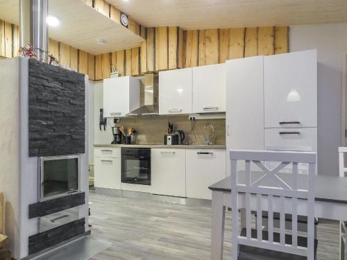 a kitchen with white cabinets and a stove at Holiday Home Hilla b by Interhome in Saariselka