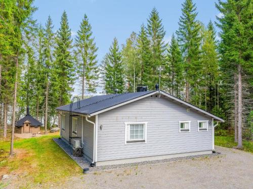 a small house in the middle of a forest at Holiday Home Kaisla by Interhome in Pertunmaa