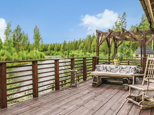 a wooden deck with a bench and a gazebo at Holiday Home Ruuhikari by Interhome in Ulvila