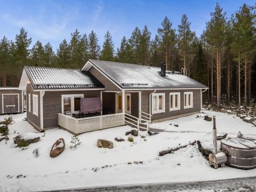a small house in the snow with trees at Holiday Home Kalaranta by Interhome in Lihavanpää