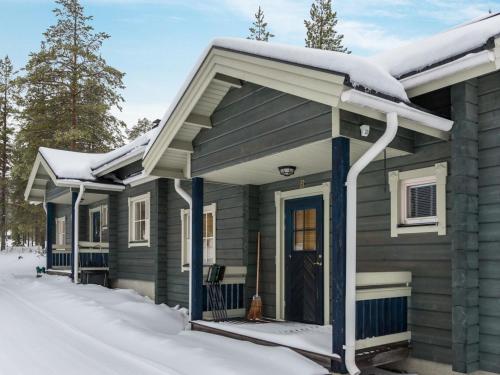a house with snow on the roof at Holiday Home Ylläskaira a by Interhome in Äkäslompolo