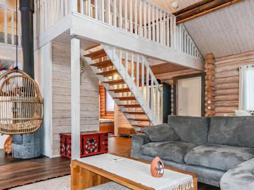 a living room with a staircase in a house at Holiday Home Isopyhänmaa by Interhome in Salla