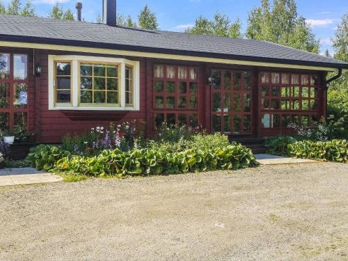 a house with a bunch of flowers in front of it at Holiday Home Eden by Interhome in Kuusa