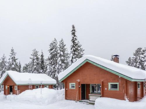 a log cabin with snow on the roof at Holiday Home Lomamaja 2 by Interhome in Raattama