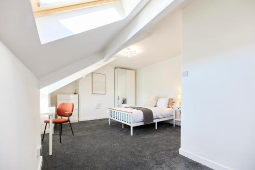 a bedroom with a bed and a desk and a chair at Aura - Elegant Retreat in Prime Leeds Location! in Headingley