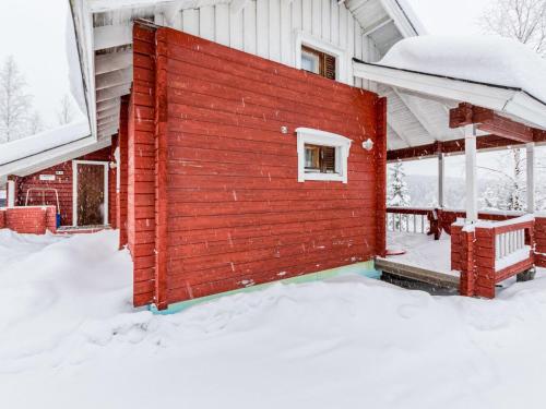 a small red building in the snow at Holiday Home Lomapesä 2b by Interhome in Kotila