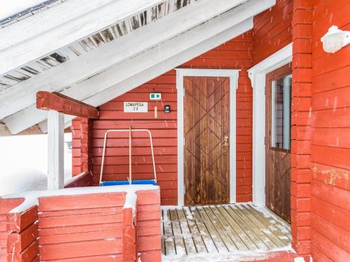 a small red building with a door in it at Holiday Home Lomapesä 2b by Interhome in Kotila