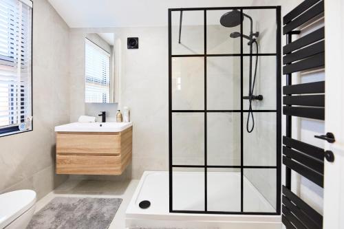 a bathroom with a shower and a sink at Aura - Elegant Retreat in Prime Leeds Location! in Headingley