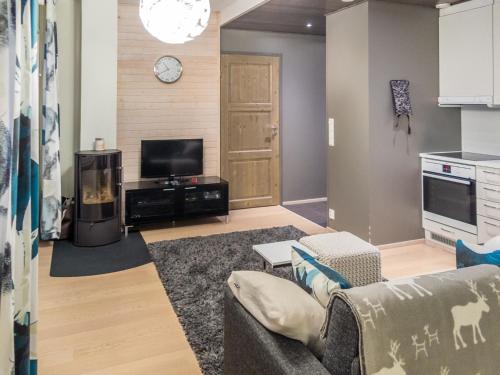 a living room with a couch and a tv at Holiday Home Levin stara c11 by Interhome in Levi