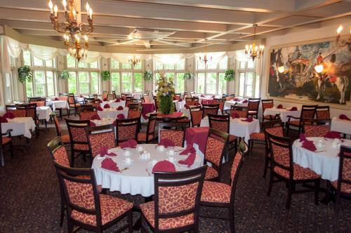 a dining room with white tables and chairs at Glynmill Inn in Corner Brook