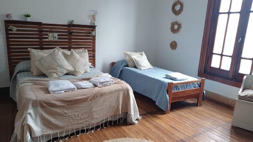 a bedroom with two beds and a table with towels at Lo de Ignacio Parada obligatoria in Gualeguaychú