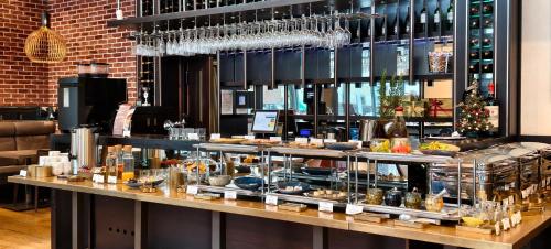 a buffet line with food on display in a restaurant at Europeum Hotel in Wrocław