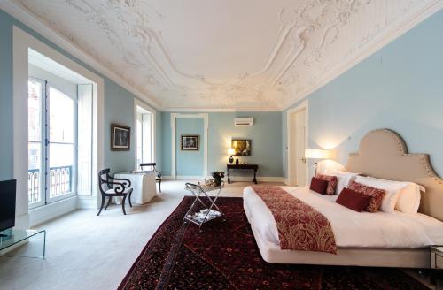 a bedroom with a large bed and a living room at Dear Lisbon - Palace Chiado Suites in Lisbon