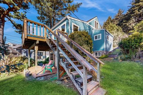 a blue house with a wooden staircase in the yard at Carolyn's Dream in Oceanside