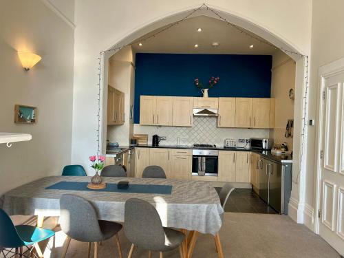 a kitchen with a table and chairs in a room at Queens Gate in Portsmouth