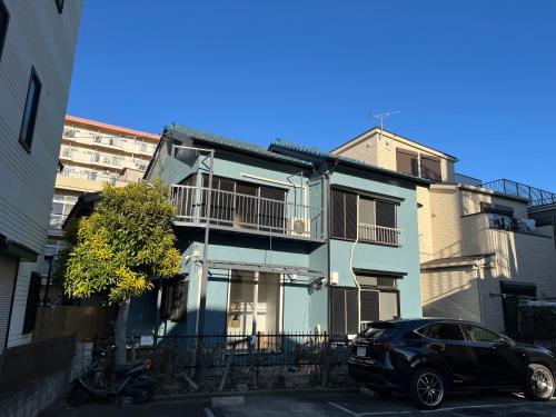 a black car parked in front of a building at shine house warabi2 in Warabi