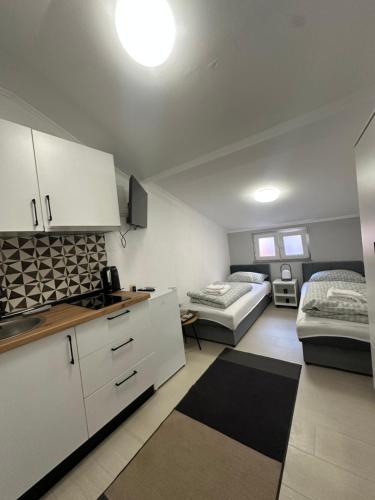 a room with a kitchen and a bed in it at Mira Apartmani in Mostar