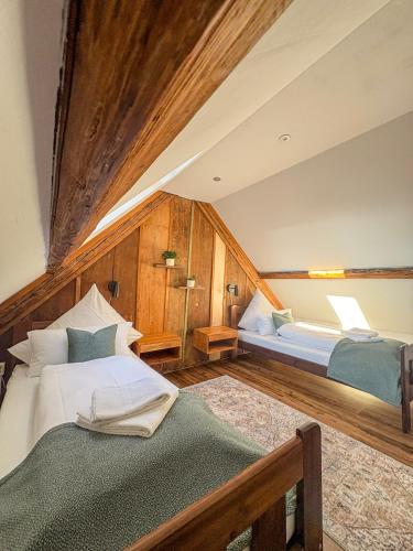 a bedroom with two beds in a attic at Wohnen in der Altstadt - Wohnungen und Studio in Gundelsheim
