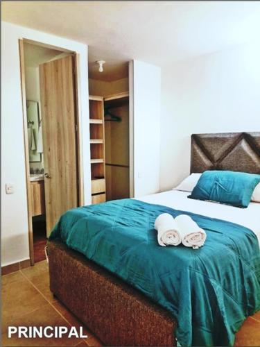 a bedroom with a bed with two towels on it at Capriella,Cartagena in Cartagena de Indias