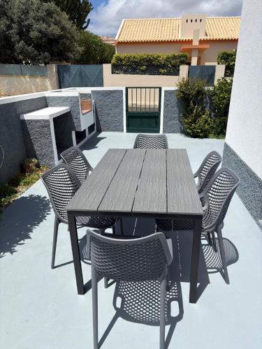a wooden table and chairs on a patio at Beach Relax Apartment in Porto Santo