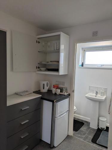 a small kitchen with a counter and a sink at Special Offer CORBY En- Suite Double Room Near Rockingham Min 4 night stay for Couples or Single person Available in Shared property & fully equipped in Rockingham