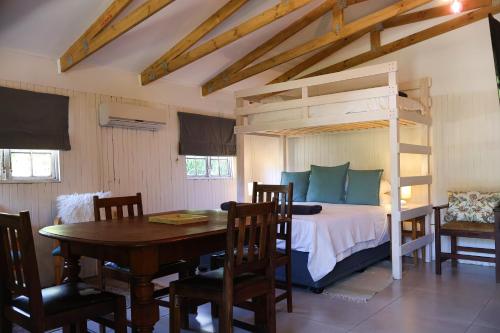 a bedroom with a bunk bed and a table and chairs at Stonehaven Clarens in Clarens