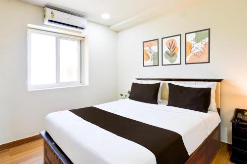 a bedroom with a large bed in a room at Townhouse Gachibowli Near Gopichand Academy in Hyderabad
